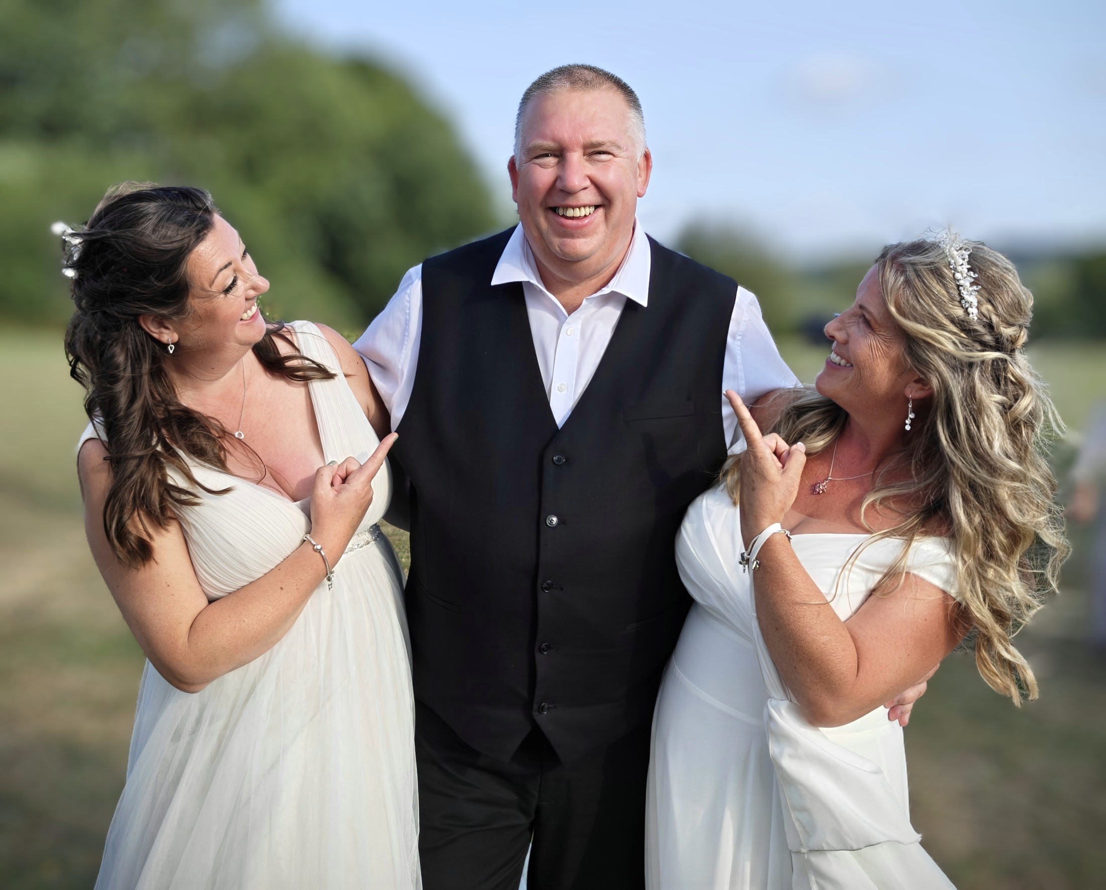 DJ Mike Hackett with a newly married couple outdoors