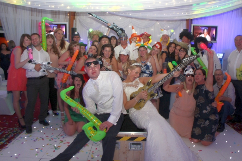 Wedding guests enjoying inflatable props from the Tomfoolery Box